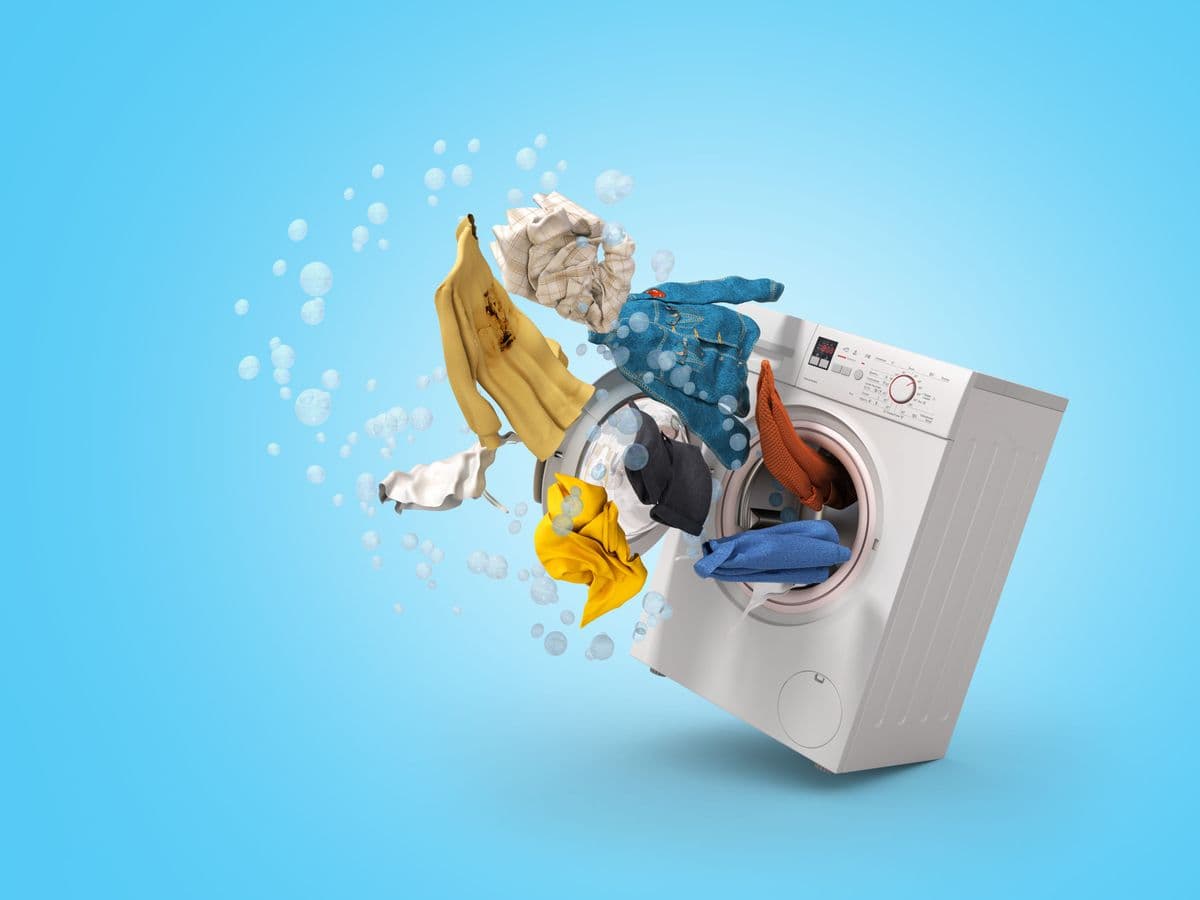 Trust Wash team member caring for freshly cleaned laundry